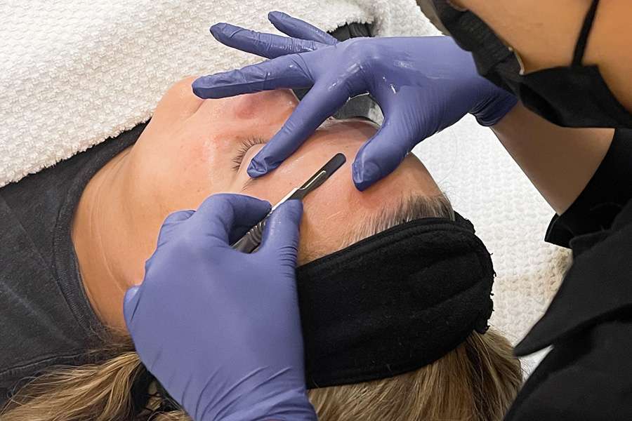 dermaplaning facial Woman getting a dermaplaning facial service.