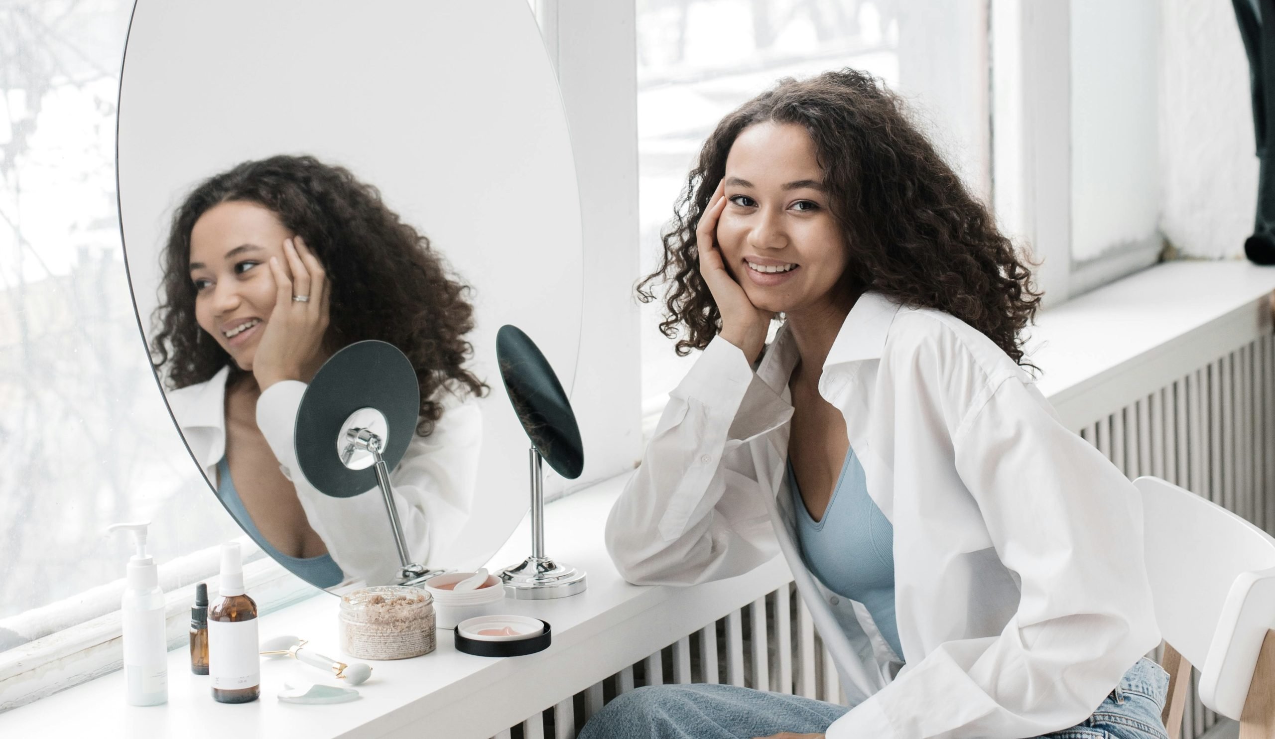 Beautiful skin Person with skin that fluctuates with sun exposure seated near mirror