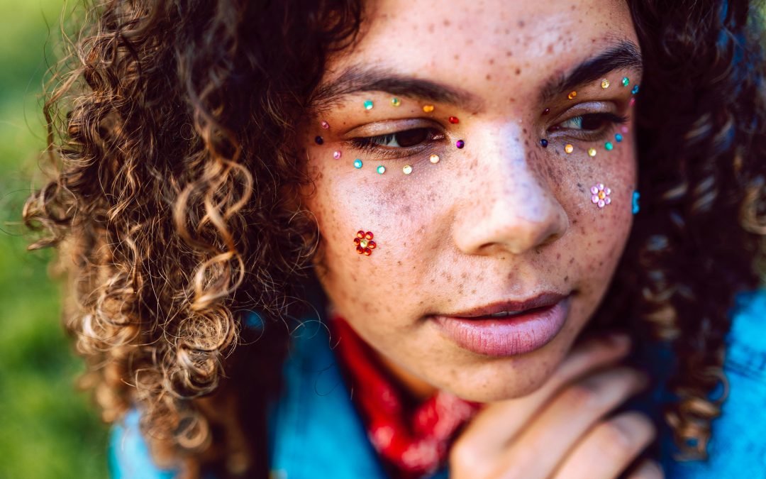 A person who uses products to avoid hyperpigmentation spots. They also have fun stick-on facial jewels.