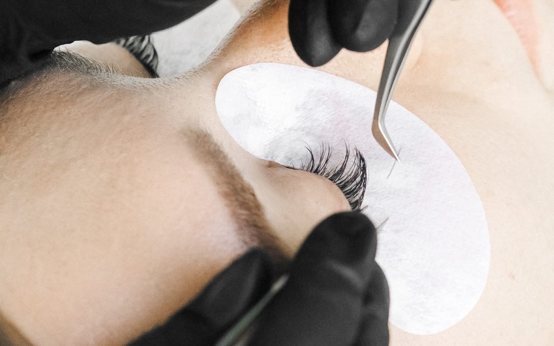 Best Lashes Headingley - a lash extension service in Winnipeg showing a close-up of an extension about to be placed on a natural lash.
