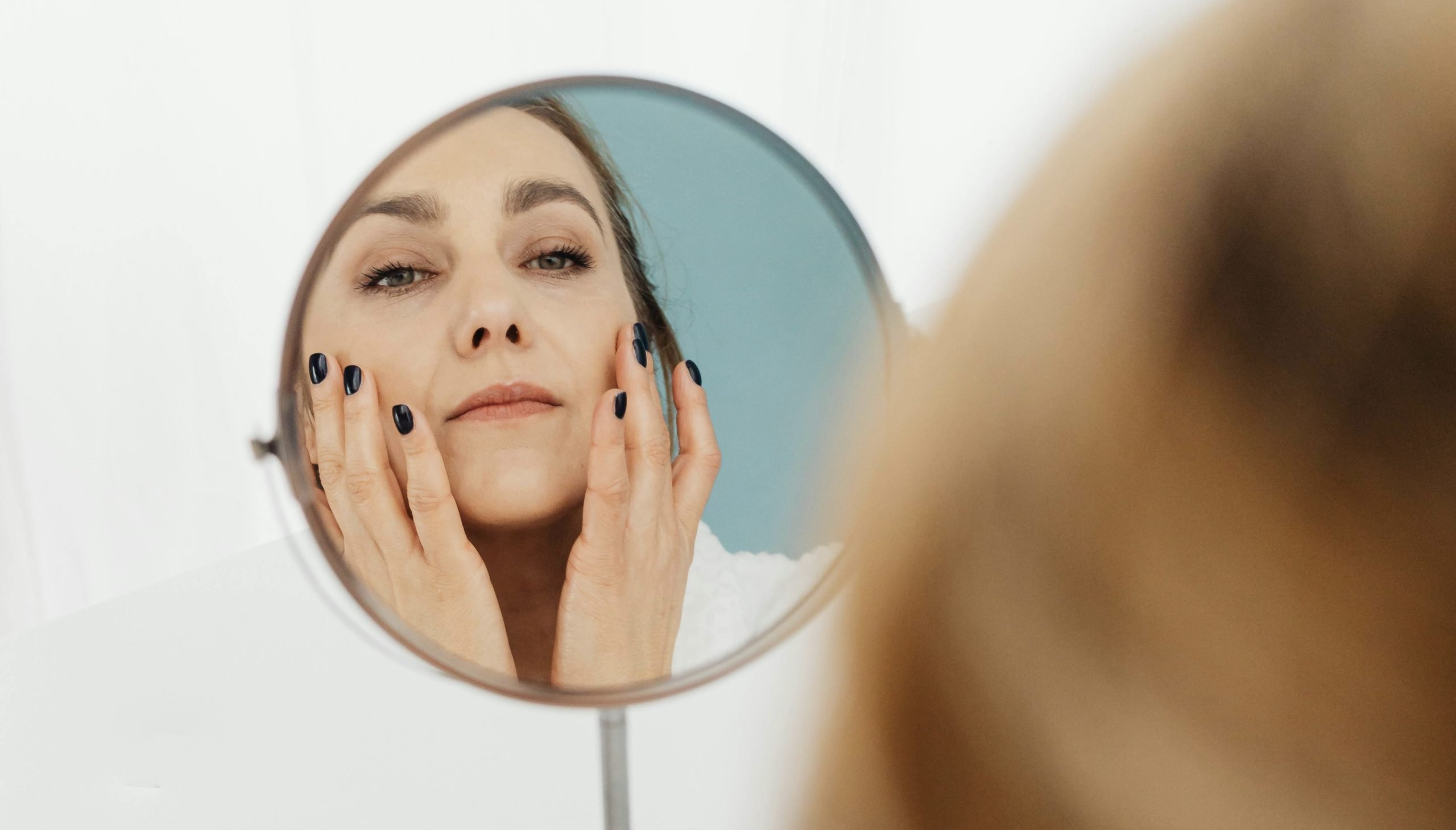 treatments for wrinkles in winnipeg a person looking into a round mirror at her wrinkles