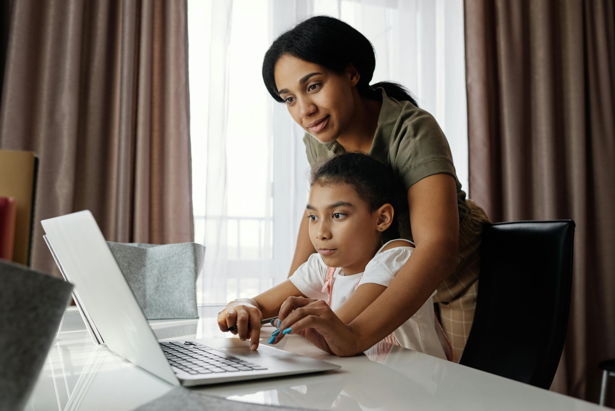 mother helping her child do homework ( Mother's Day content )