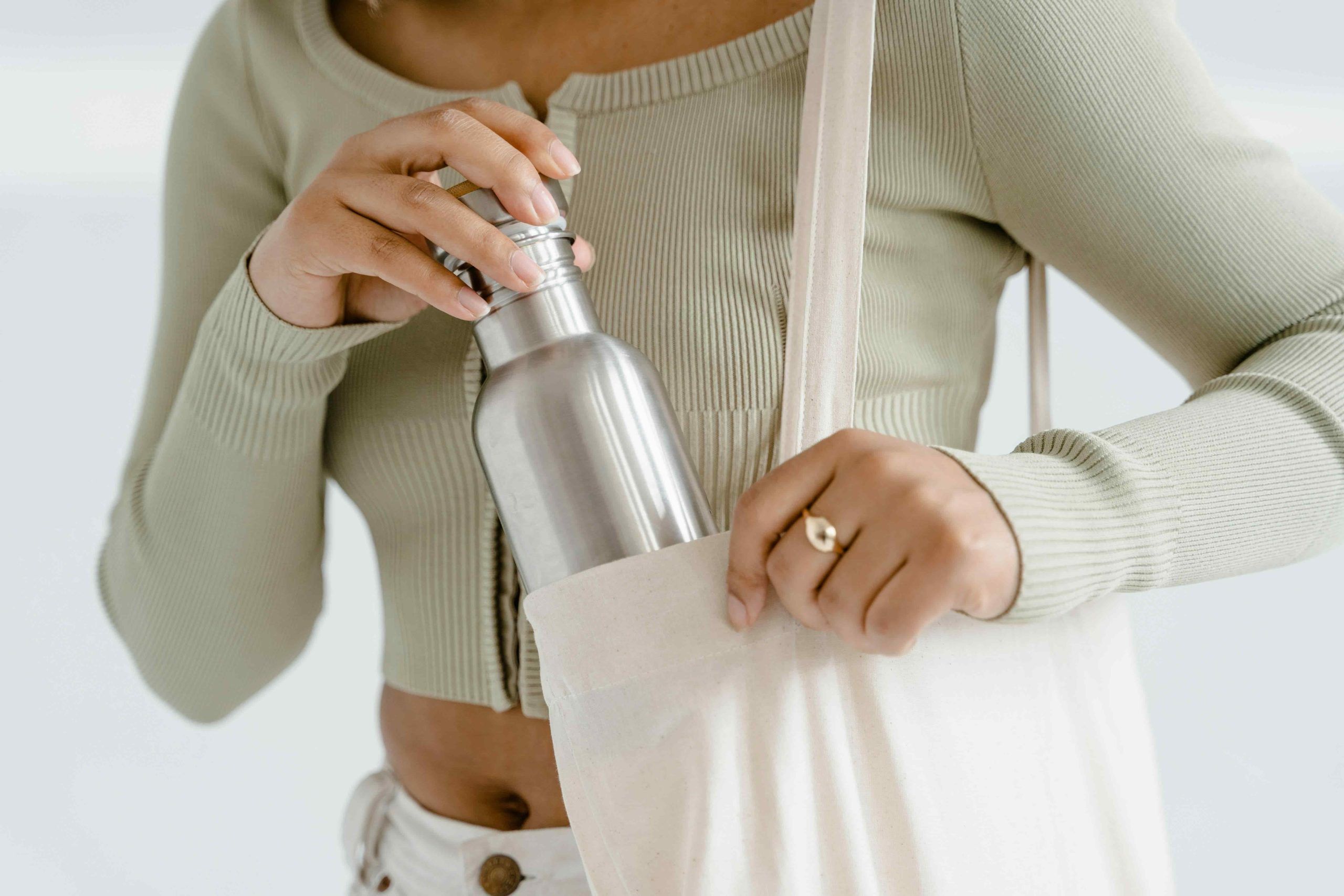Skincare Tips for Travelling: carrying a reusable water bottle to stay hydrated on flights and keep skin from drying out.